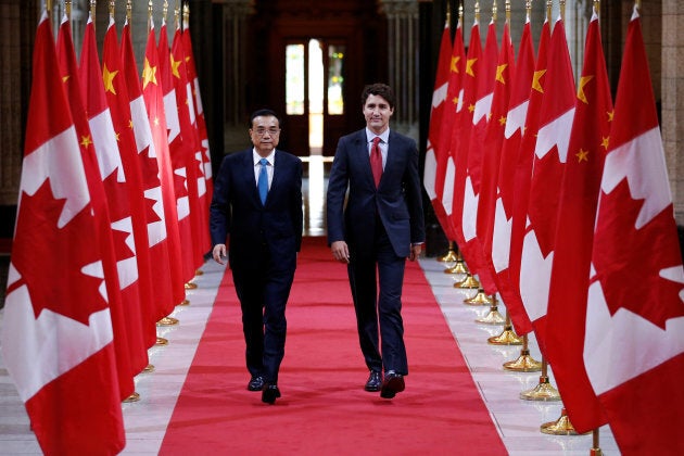 Prime Minister Justin Trudeau and Chinese Premier Li Keqiang walk in the Hall of Honour on Parliament...