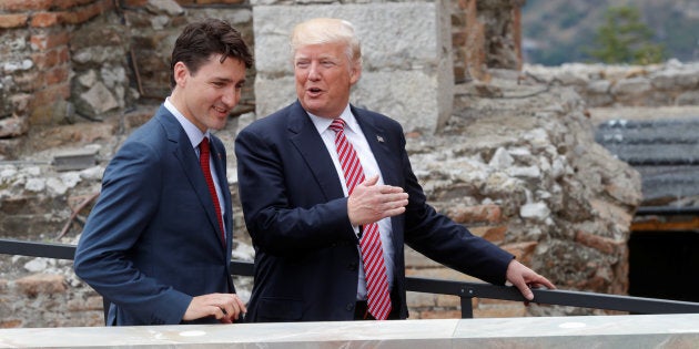 Prime Minister Justin Trudeau and U.S. President Donald Trump arrive for a photo during the G7 Summit in Sicily, Italy on May 26, 2017.