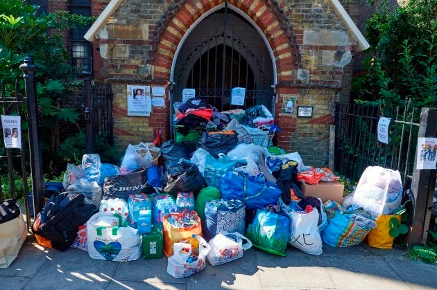 Donations left for those affected by the June 14 fire at the Grenfell Tower block are pictured outside a church in Kensington, west London, on June 17, 2017, following the June 14 fire at the residential building.