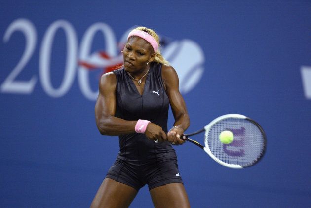 Serena Williams of the USA returns a shot to her sister Venus Williams of the USA during the women's final of the US Open at the USTA National Tennis Center on September 7, 2002 in Flushing Meadows-Corona Park, New York. (Photo by Al Bello/Getty Images)