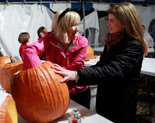 Laureen Harper hollows out a pumpkin with Rona Ambrose at 24 Sussex Drive in Ottawa October 30, 2012.
