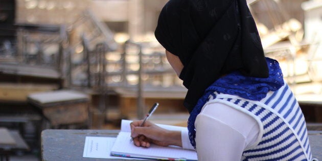 Rama studying in an accommodation centre where she stayed during exam period.