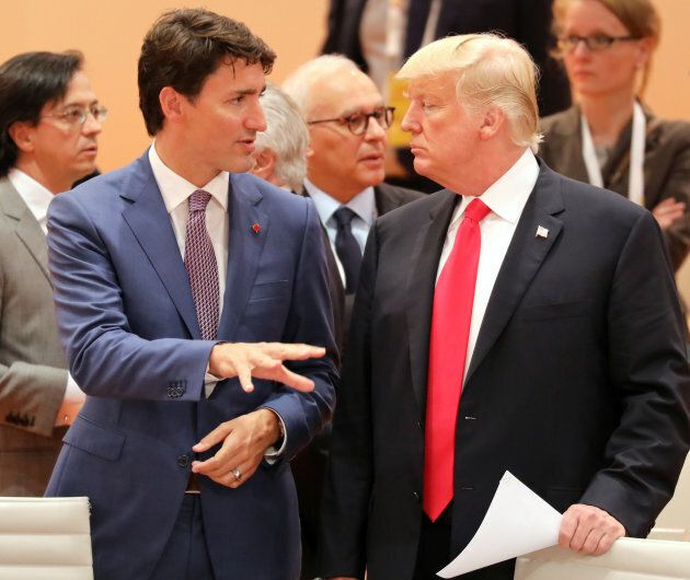 U.S. President Donald Trump (R) talks with Canada's Prime Minister Justin Trudeau at the beginning of the third working session of the G20 meeting in Hamburg, northern Germany, on July 8, 2017.