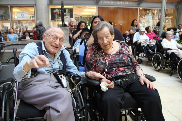 Baycrest resident and Holocaust survivor Rosa Weisberg (right) sits with husband Sam Weisberg while enjoying the 2017 Baycrest Prom.