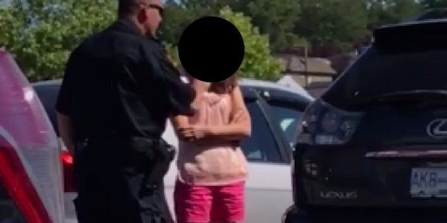 A Vancouver Police officer lectures a woman for leaving her children in a hot car earlier this week. (Facebook)