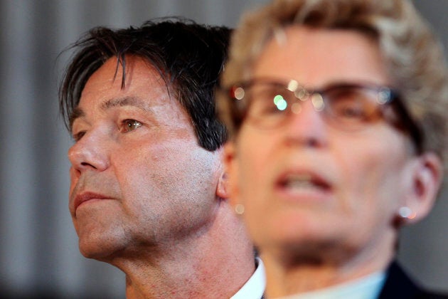 Health Minister Eric Hoskins (L), listens to Premier Kathleen Wynne speak during a media event on April 28, 2017.