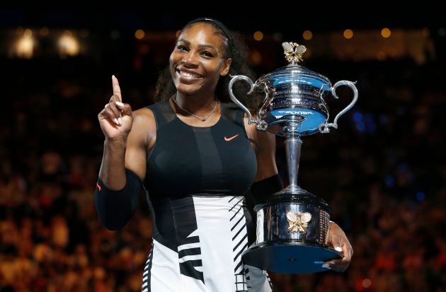 Serena Williams of the U.S. gestures while holding her trophy after winning her Women's singles final match against Venus Williams of the U.S. REUTERS/Issei Kato TPX IMAGES OF THE DAY