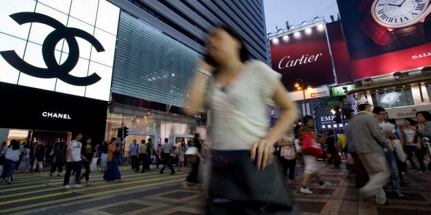 Pedestrians walk past a Chanel outlet in Hong Kong, China.