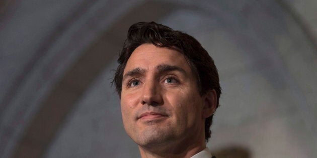 Prime Minister Justin Trudeau listens to a question as he speaks with the media in the foyer of the House of Commons on Dec. 15, 2016.