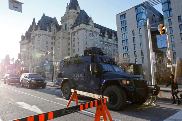 A Royal Canadian Mounted Police vehicle passes the Fairmont Chateau Laurier as it leaves a secure area downtown following shootings in Ottawa Oct. 22, 2014.