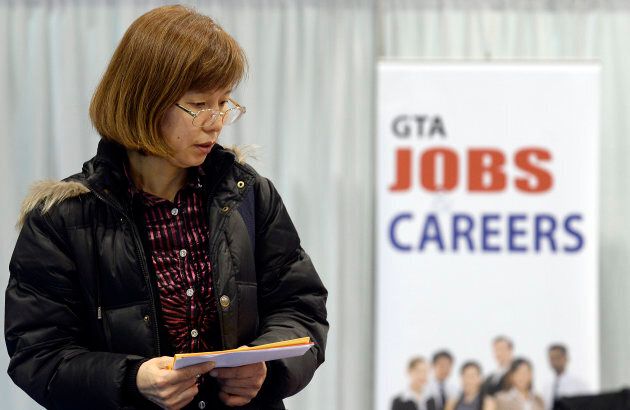 A woman walks through the 2014 Spring National Job Fair and Training Expo in Toronto, Ont. April 3, 2014.