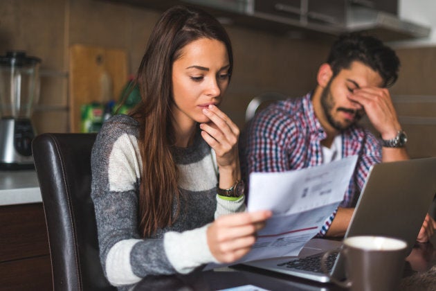 Couple looking at the bills and planning their expenses.