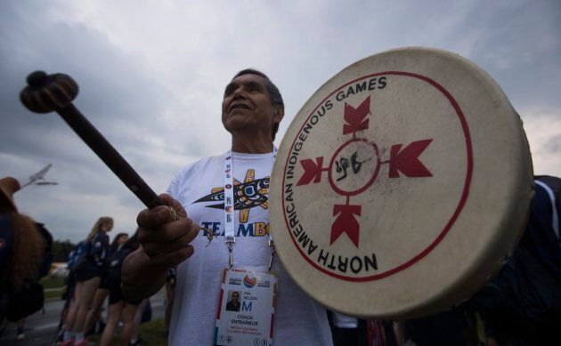 A member of the British Columbian delegation beats a drum before the opening ceremony of the 2017 North American Indigenous Games, in Toronto on July 16, 2017.