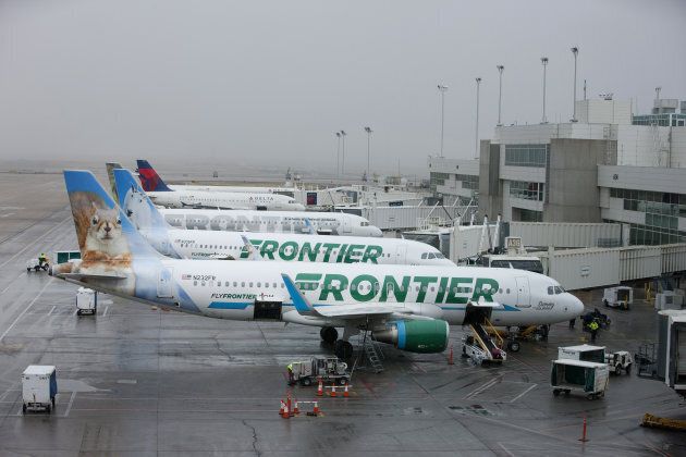 Frontier Airlines Inc. planes sit at gates at Denver International Airport in Denver, Colo., on April 4, 2017.