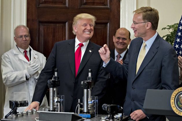 U.S. President Donald Trump smiles after participating in a glass strength test of a Corning Valor vial with Wendell Weeks, chairman and chief executive officer of Corning Inc., right, during an announcement on a new pharmaceutical glass packaging initiative in the Roosevelt Room of the White House in Washington, D.C., U.S., on July 20, 2017.