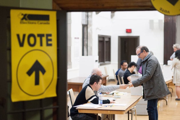 Voters cast ballots during the federal election in Toronto, Ont., on Oct. 19, 2015.