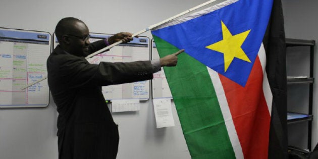 Philip Gai holds a South Sudanese flag in January, 2011 after the referendum vote to become a separate state from Sudan.