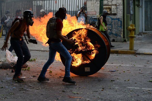 Opposition demonstrators clash with riot police ensuing an anti-government protest in Caracas, on July 26, 2017.