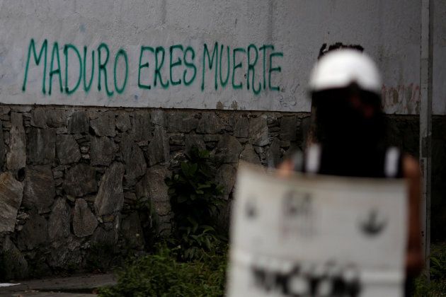 Graffiti that reads "Maduro is death" is seen next to a roadblock during a strike called to protest against Venezuelan President Nicolas Maduro's government in Caracas, Venezuela July 26, 2017.