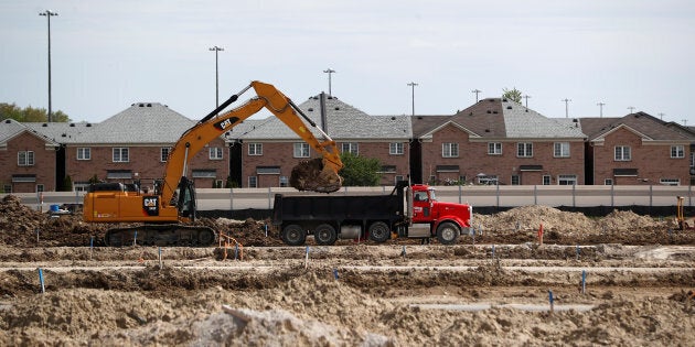 Construction workers build homes on a lot in Vaughan, a suburb with an active real estate market, in Toronto, Ont., May 24, 2017.