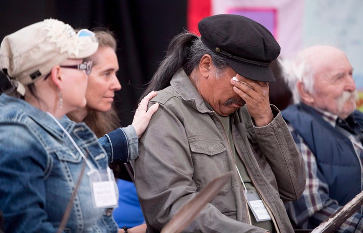 Dennis Shorty wipes away tears after speaking about residential schools at the National Inquiry into Missing and Murdered Indigenous Women and Girls taking place in Whitehorse, Yukon, Tuesday, May 30, 2017.