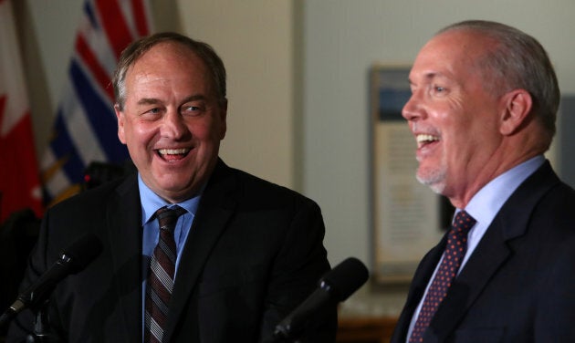 British Columbia Green leader Andrew Weaver and New Democrat leader John Horgan answer questions in the British Columbia legislature building in Victoria on May 30, 2017.