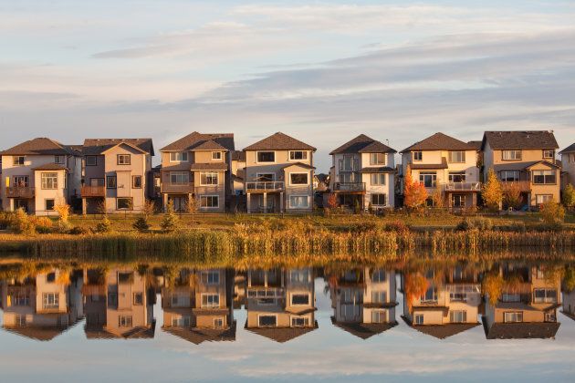 A row of houses reflected in a pond in Calgary, Alta. Calgary is one of six major cities to see an improvement in home affordability in the second quarter of 2017.