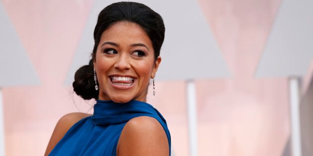 Actress Gina Rodriguez, wearing a bright blue Manon Gabard gown, arrives at the 87th Academy Awards in Hollywood, California February 22, 2015. Rodriguez recently won a Golden Globe for her role in