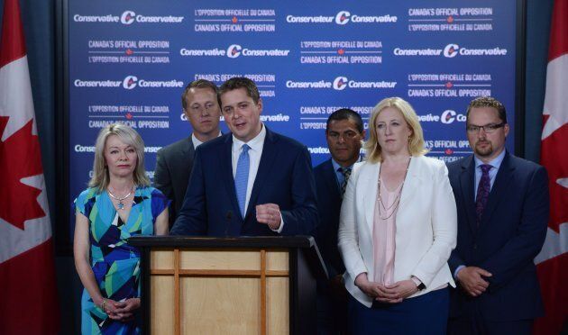 Conservative Leader Andrew Scheer makes an announcement with MPs Candice Bergen, Chris Warkentin, Alain Rayes, Lisa Raitt, and Mark Strahl, at the National Press Theatre in Ottawa on July 20, 2017.