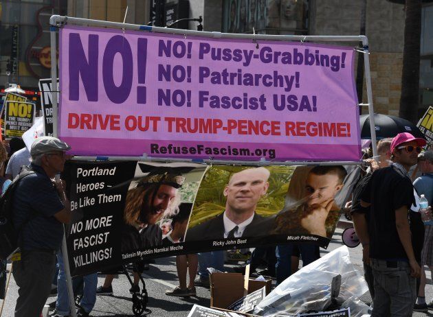 Demonstrators hold a banner at an anti-Trump protest organized by Refuse Fascism L.A. at the site of Trump's star on the Walk of Fame in Hollywood, Calif., on July 15, 2017.