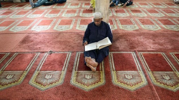 An Egyptian worshipper reads from the Koran, Islam's holy book, inside the 10th century historic al-Azhar mosque, in the capital Cairo's Islamic quarter on April 26, 2017. Pope Francis is visiting Egypt on April 28, 2017, and he is scheduled to meet with Ahmed al-Tayeb, the grand imam of Al-Azhar, Egypt's highest institution of Sunni Islam.