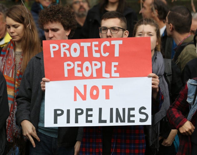 Protesters hold a rally at City Hall before a march against the proposed expansion of Kinder Morgan's Trans Mountain Pipeline in Vancouver, Nov. 19, 2016.