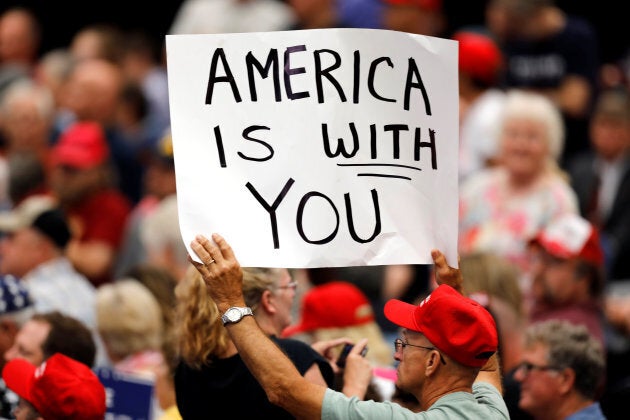 A supporter holds a sign during a rally with President Donald Trump at the U.S. Cellular Center in Cedar Rapids, Iowa, June 21, 2017.