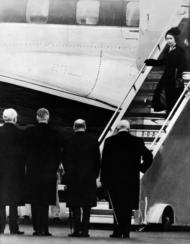 Queen Elizabeth II of England gets off plane, greeted by (from R to L) Sir Winston Churchill, Clement Attlee, Anthony Eden and Frederick James Marquis, 1st Earl of Woolton and Lord President of the Council, 08 February 1952, as she returns from Kenya. Queen Elizabeth II was proclaimed Sovereign of each of the Commonwealth Realms on 06 February 1952, after the death of her father King George VI in the night between 05 February and 06 February 1952. Princess Elizabeth heard the news of her father's death while staying at Treetops, a Game Lodge, in Kenya. (OFF/AFP/Getty Images)