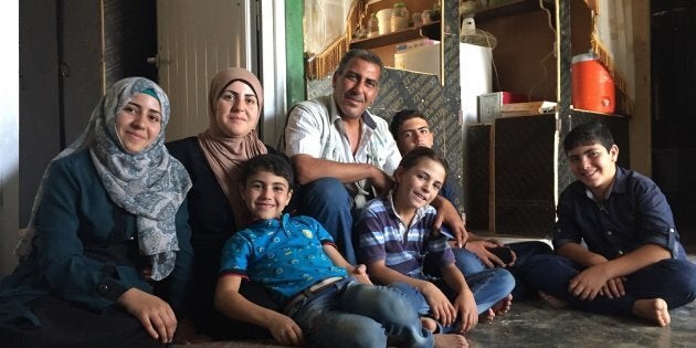 Omaima (far left) and her family at home in Za’atari refugee camp, Jordan. Step by step they have made their container like a home.