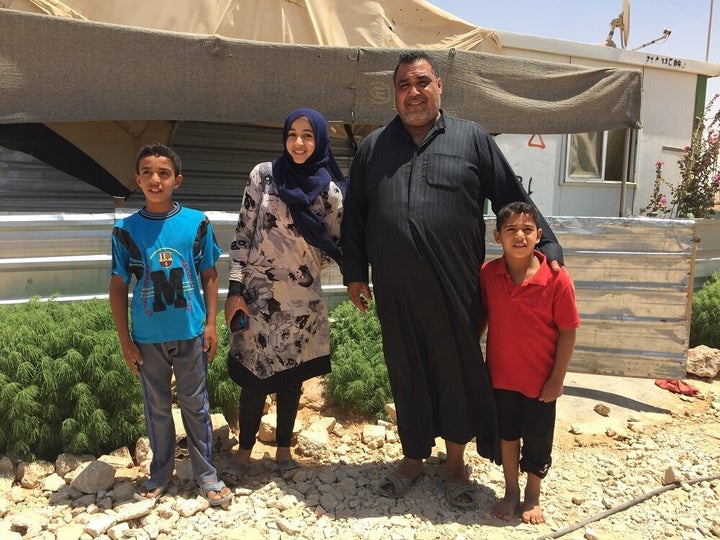 Abu Kareem with three of his four children outside their home in Za'atari refugee camp.