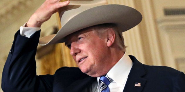 U.S. President Donald Trump wears a cowboy hat as attends a