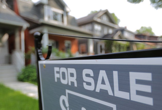 A sign advertises a house for sale in midtown Toronto, Ontario, July 12, 2017. More than half of analysts polled by Reuters in May said a sharp housing slowdown is somewhat or very likely in Canada.