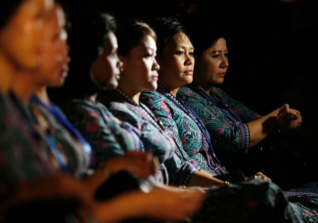 Malaysia Airlines air stewardesses look on during a memorial for victims of MH370 and MH17 at Malaysia Airlines headquarters in Kuala Lumpur July 25, 2014.