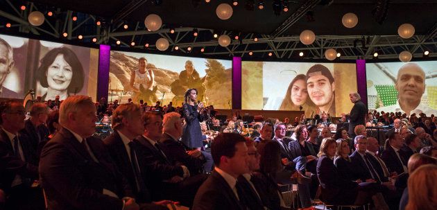 Photos of the victims of Malaysian Airlines MH17 are screened during a national memorial at the RAI convention center in Amsterdam Nov. 10, 2014.