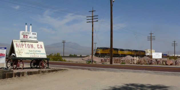 A photo of the railroad crossing in Nipton, Calif. Cannabis company American Green has bought the town's land and facilities in order to develop a marijuana tourism destination.