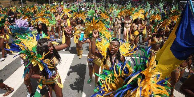 Paraders dance as they make their away around the parade route during the 2015 Caribana Parade at the Exhibition grounds on August 1, 2015. (Cole Burston/Toronto Star via Getty Images)