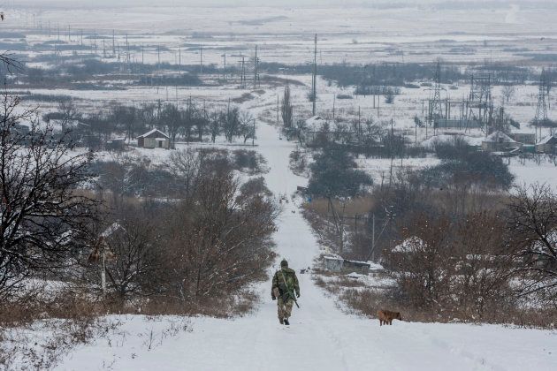 A file image of a Ukrainian soldier patrolling near Troitske, one of the closest villages to the eastern front lines.