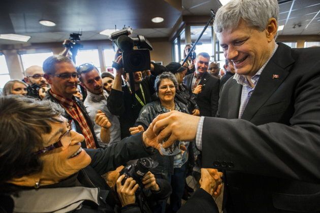 Stephen Harper hands out coffee at a Tim Horton's restaurant in Fredericton, N.B. on Oct. 16, 2015.