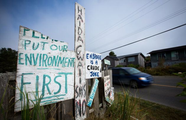 Handmade anti-pipeline signs are seen on the side of a road in the First Nations village of Old Massett, B.C., on Aug. 25, 2016.