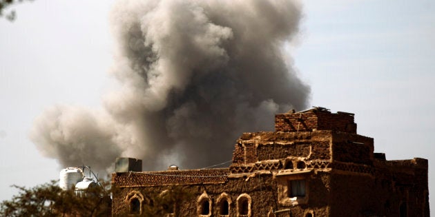 Smoke billows behind a building following a reported air strike by the Saudi-led coalition in the Yemeni capital Sanaa on Jan. 22, 2017.