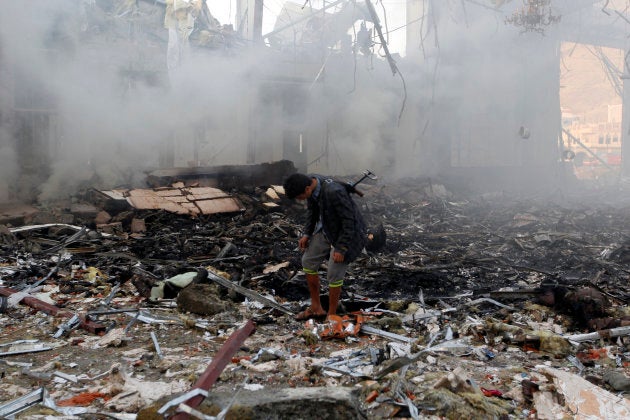 A Yemeni inspects the rubble of a destroyed building following reported airstrikes by Saudi-led coalition air-planes on the capital Sanaa on Oct. 8, 2016.