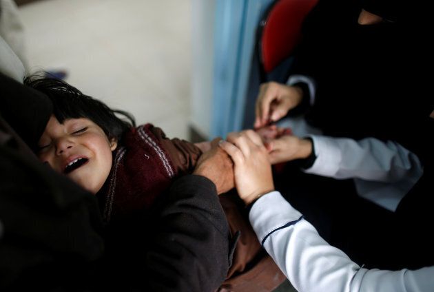 Nurses tend to a boy who is suspected of being infected with cholera at a cholera treatment center in Sanaa, Yemen, May 15, 2017.
