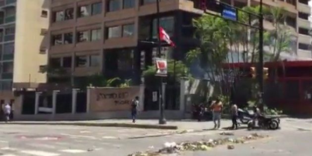 A screengrab of a video posted to Twitter shows smoke rising at the Canadian embassy in Caracas.