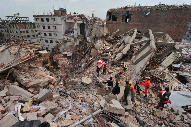 Rescue workers attempt to find survivors from the rubble of the collapsed Rana Plaza building.